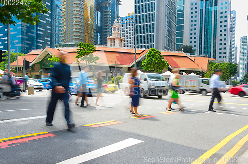 Image of Motioned people crossing road Singapore 