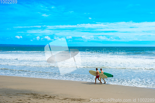 Image of Two man surfing beach