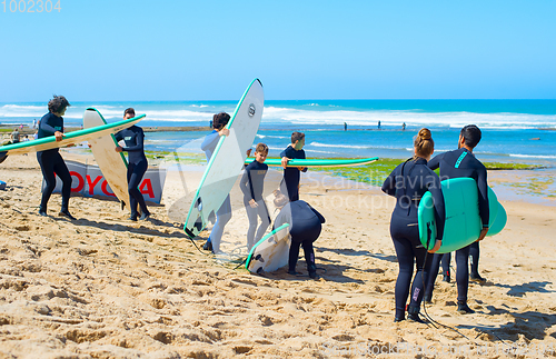 Image of Group of surfers beach surfing