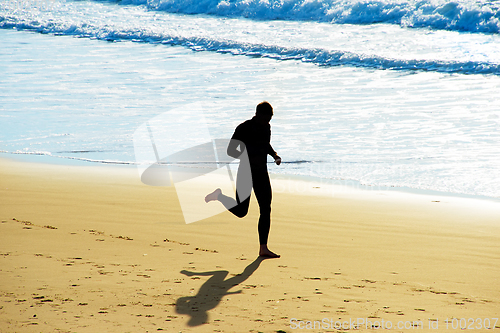 Image of Man jogging on a beach
