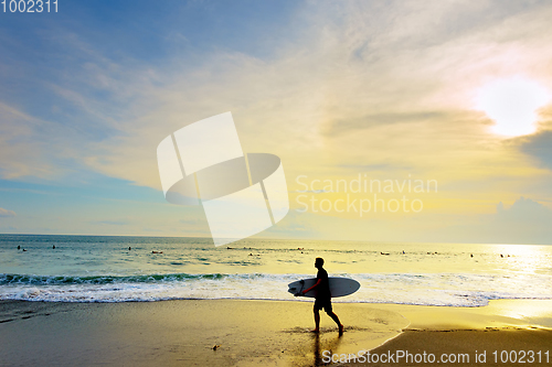 Image of Surfer with surfboard beach. Bali