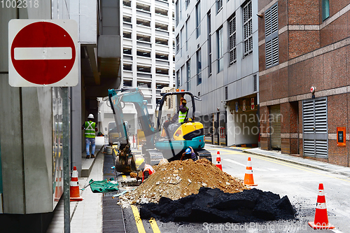 Image of Singapore road workers fixing problem