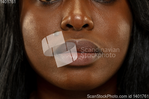 Image of Young african woman isolated on yellow studio background, facial expression