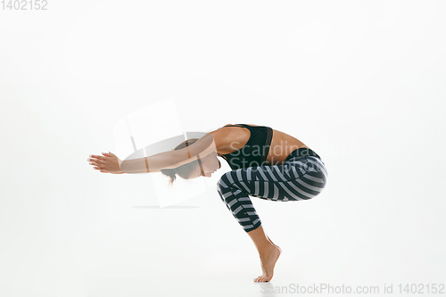 Image of Sporty young woman doing yoga practice isolated on white background