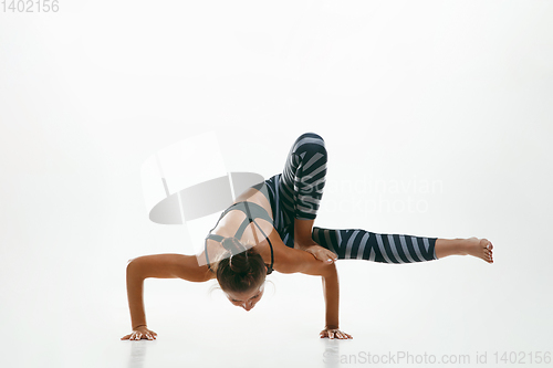 Image of Sporty young woman doing yoga practice isolated on white background