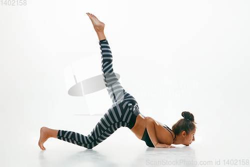 Image of Sporty young woman doing yoga practice isolated on white background