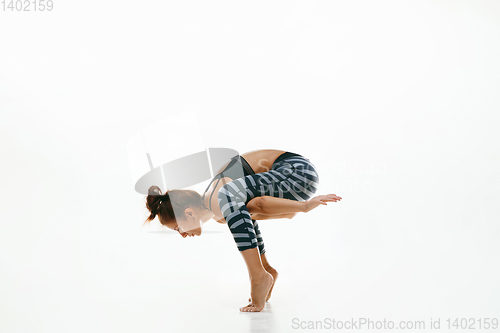 Image of Sporty young woman doing yoga practice isolated on white background