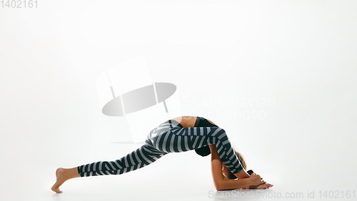 Image of Sporty young woman doing yoga practice isolated on white background