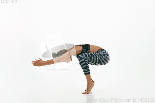 Image of Sporty young woman doing yoga practice isolated on white background