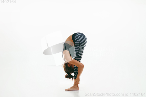 Image of Sporty young woman doing yoga practice isolated on white background