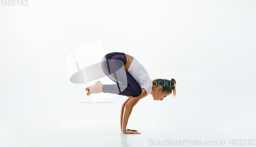 Image of Sporty young woman doing yoga practice isolated on white background