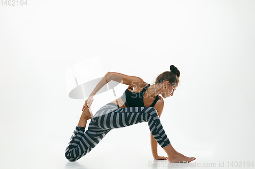 Image of Sporty young woman doing yoga practice isolated on white background