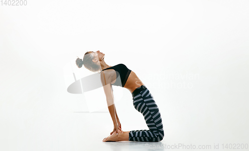 Image of Sporty young woman doing yoga practice isolated on white background