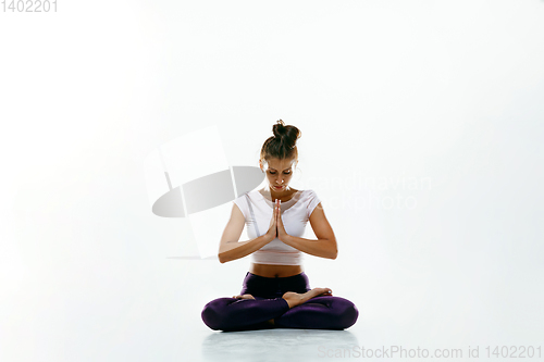 Image of Sporty young woman doing yoga practice isolated on white background