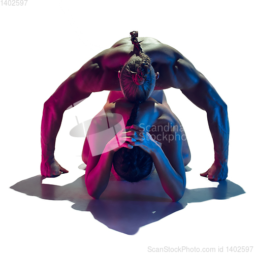 Image of Sensual fit couple isolated on white studio background in neon light