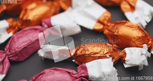 Image of Christmas candy lying on the table with camera in motion closeup