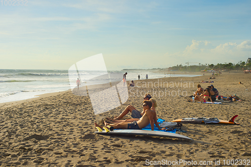 Image of Surfers relaxing on the beach