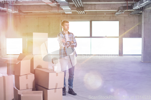 Image of portrait of young businessman on construction site