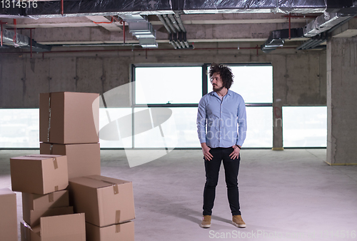 Image of portrait of young businessman on construction site