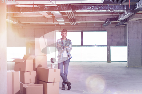 Image of portrait of young businessman on construction site