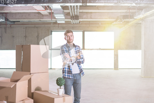 Image of portrait of young businessman on construction site