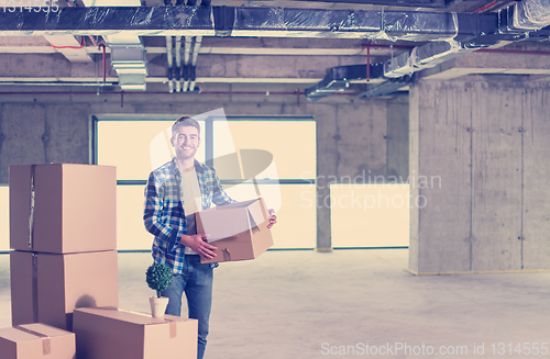 Image of portrait of young businessman on construction site