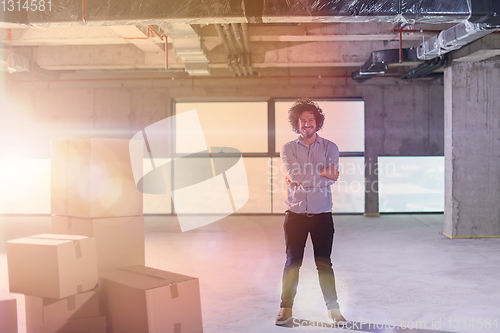 Image of portrait of young businessman on construction site