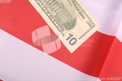Image of ten dollar bill in front of the American flag