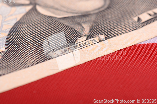 Image of twenty dollar bill in front of the American flag