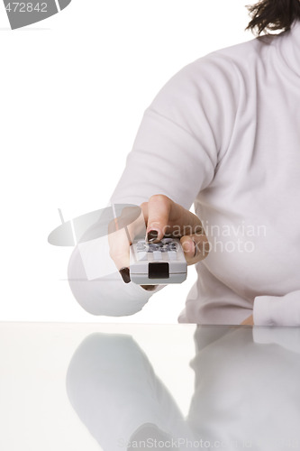Image of Holding and pointing a remote control
