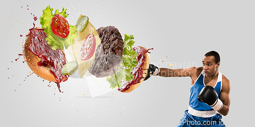 Image of Burger\'s crashing by the boxer isolated on white background