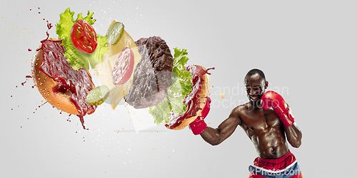 Image of Burger\'s crashing by the boxer isolated on white background