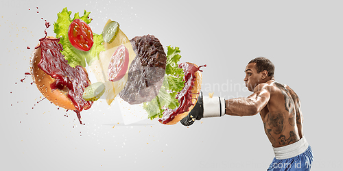 Image of Burger\'s crashing by the boxer isolated on white background