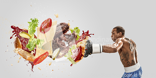 Image of Burger\'s crashing by the boxer isolated on white background