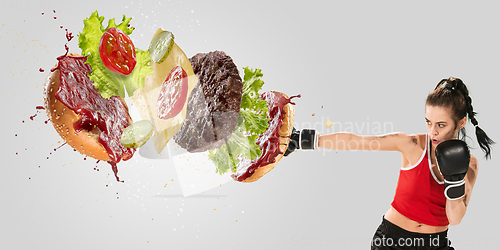 Image of Burger\'s crashing by the boxer isolated on white background