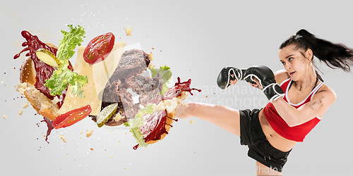 Image of Burger\'s crashing by the boxer isolated on white background