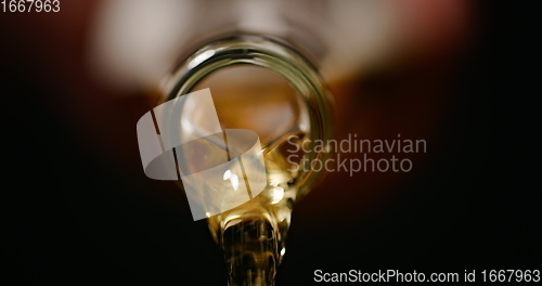 Image of Beer being poured against dark background with slow movements