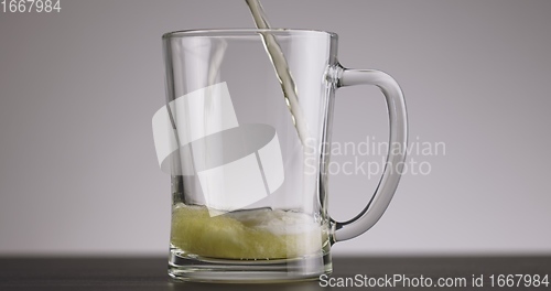 Image of Pouring beer into big mug until its full 120fps footage timelapse