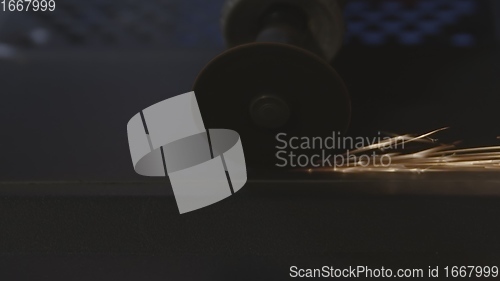 Image of Steel cutter with sparks while cutting steel bar