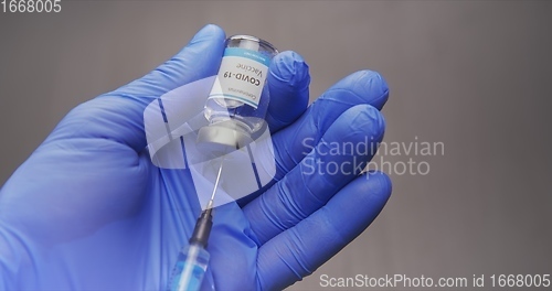 Image of Vaccine in human hands closeup footage