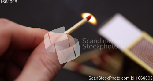 Image of Lighting up Match in hand slow motion footage