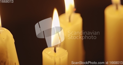 Image of Candles glowing against dark background