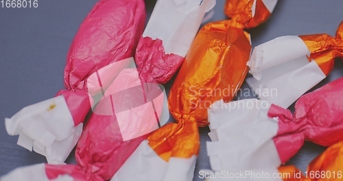 Image of Christmas candy lying on the table with camera in motion closeup