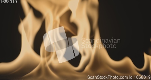 Image of Fire dancing against dark background 120fps slow motion loopable footage