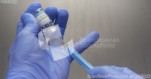 Image of Vaccine in human hands closeup footage