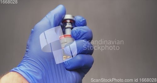 Image of Vaccine in human hands closeup footage