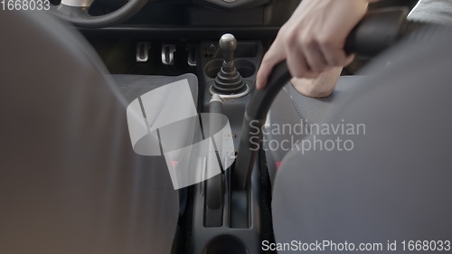 Image of Man cleaning dirty car interior with vacuum cleaner