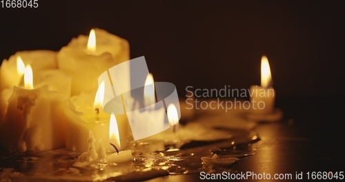 Image of Candles glowing against dark background