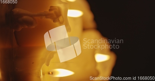 Image of Vertical video with Candles glowing against dark background