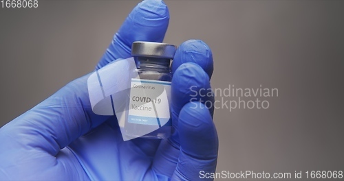 Image of Vaccine in human hands closeup footage